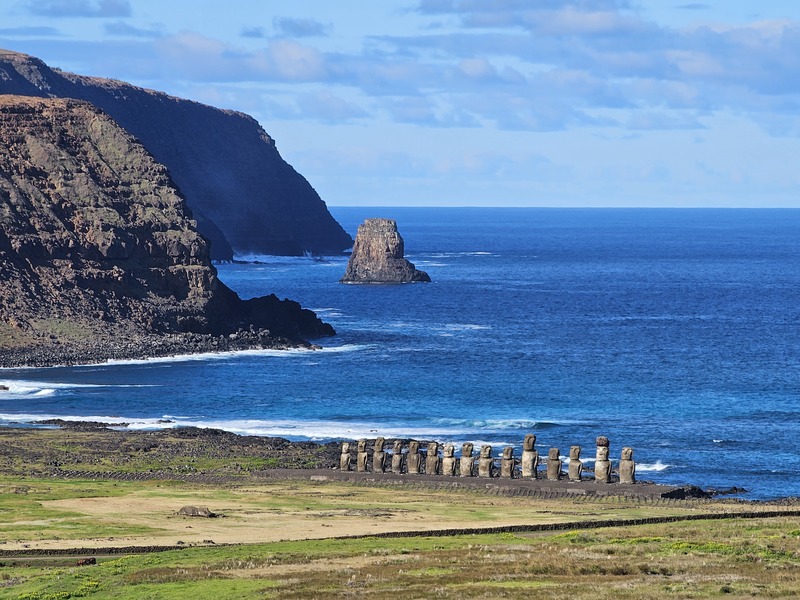 Moai in the distance above a cliff on Easter Island