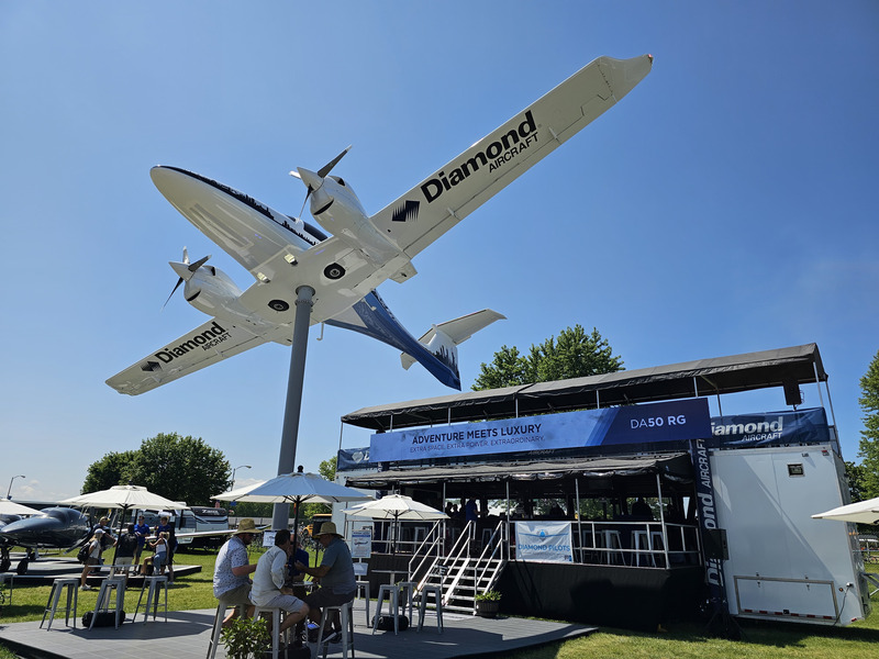 A twin-engine propeller plane on a pole about 20 feet high