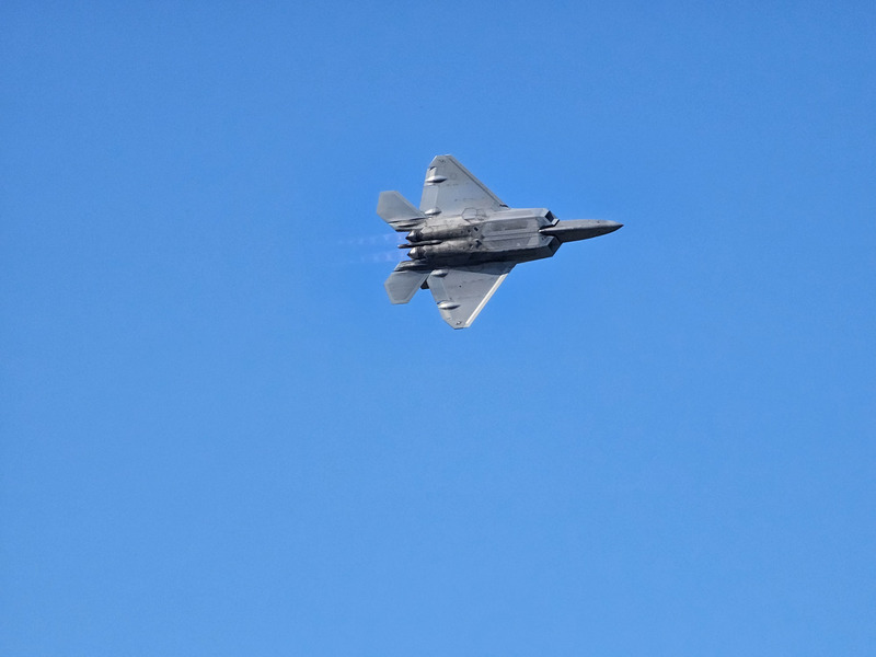 A F-22 Raptor from below with the afterburners lit